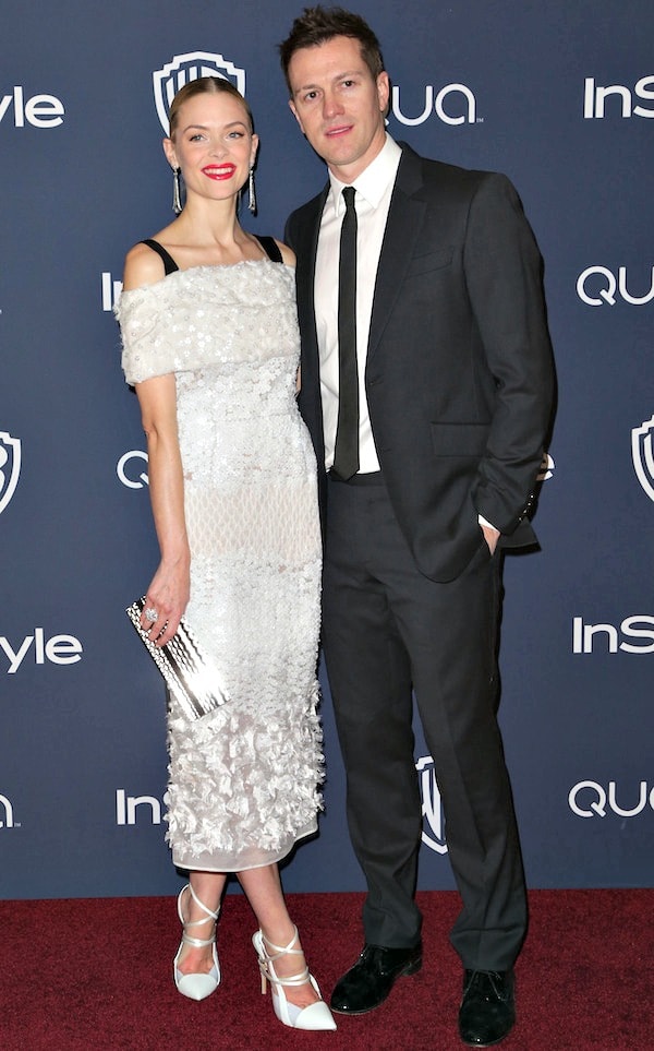 Jaime King and husband Kyle Newman posing together on the red carpet at the 2014 Golden Globes after-party; Jaime wears a white Prabal Gurung dress with statement earrings, and Kyle wears a classic tuxedo