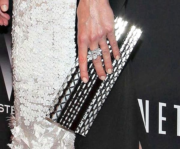 Jaime King holding a black Jimmy Choo clutch and wearing a white Prabal Gurung dress with crystal embroidery at the Weinstein Netflix Golden Globes after-party