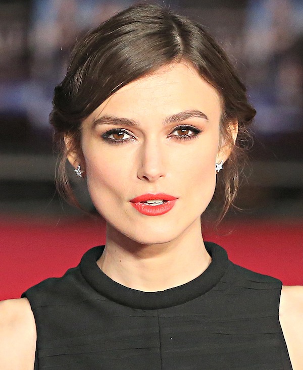 Keira Knightley's hair was styled in a wispy updo, which showcased her star-shaped earrings, kohl-rimmed eyes, and perfect red pout