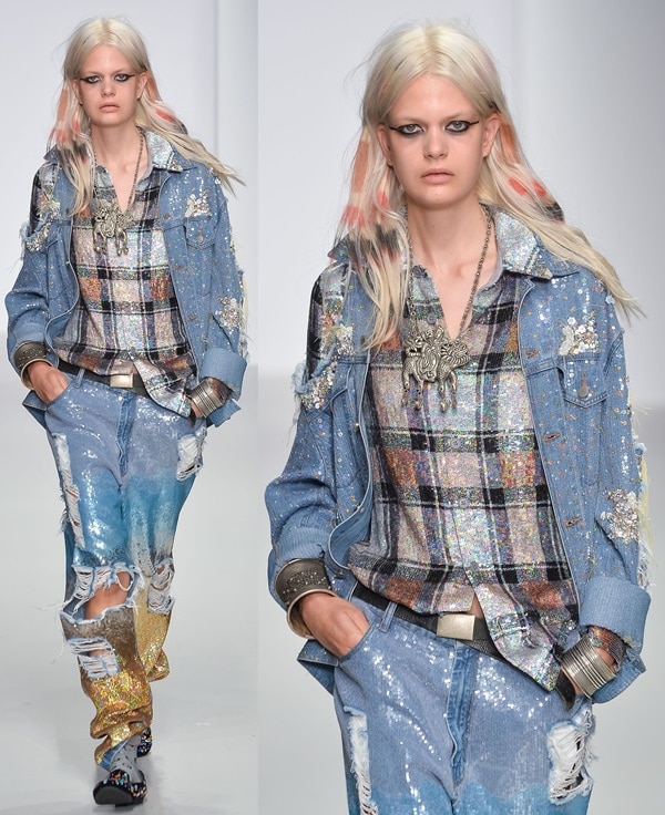 A model struts down the Ashish runway at London Fashion Week SS14 in a glitter-drenched Canadian tuxedo paired with sequined ombré jeans and sparkly platform sandals