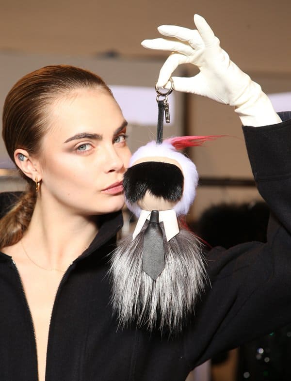 Inspired by Karl Lagerfeld, the keychain has his white hair, signature sunglasses, a high-collared shirt, and tie
