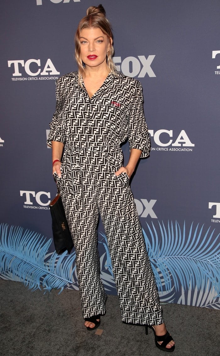 Fergie works head-to-toe Fendi monogram in a belted wide-leg jumpsuit, finishing the graphic look with black platform sandals at the FOX Summer TCA party