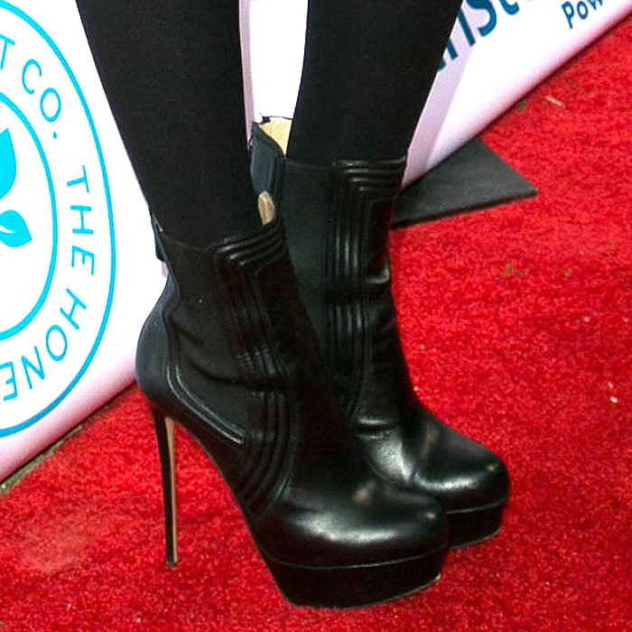 Jessica Alba grounds her look in sleek black platform booties that elevate the ensemble with street-style edge and subtle height