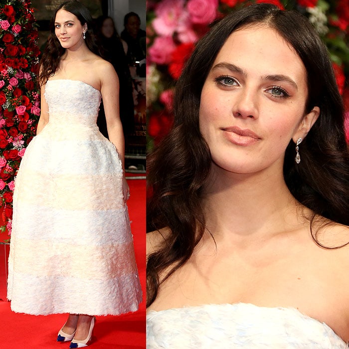Jessica Brown Findlay graced the red carpet in a romantic Christian Dior Fall 2012 couture gown featuring soft pastel hues and a modern horizontal stripe pattern, paired with striking blue-toed Christian Louboutin "Air Chance" pumps