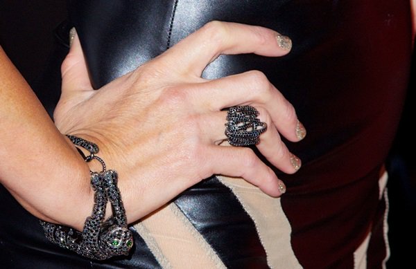 Paris Hilton accessorizes her Leather Laces look with dark gemstone serpent jewelry and glitter-tipped nails that complement the outfit’s edgy geometric detailing