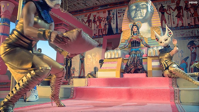 Katy Perry sits regally on her throne in a dazzling Nicolas Jebran gown