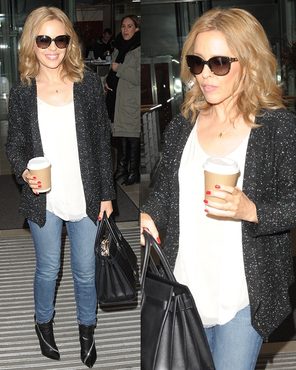 Kylie Minogue keeps it casual chic in a glittery black cardigan, white blouse, skinny jeans, and Giuseppe Zanotti zip booties while stepping out in London on February 13, 2014
