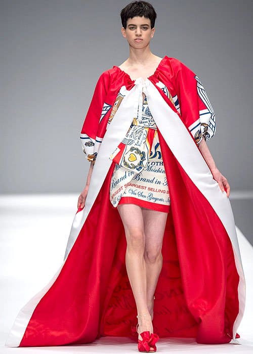 Making a memorable splash, the Moschino Fall 2014 Budweiser dress showcases Jeremy Scott's signature ability to elevate mundane branding into a striking fashion statement