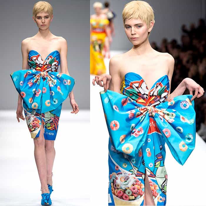 Moschino Fall 2014 presents a vibrant, strapless dress inspired by Froot Loops packaging, complete with a prominent blue bow, paired with matching blue platform heels