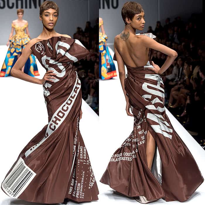 Jourdan Dunn walks the Moschino Fall 2014 runway in a striking gown designed to resemble a Hershey's chocolate bar wrapper, complete with a dramatic train and white text graphics