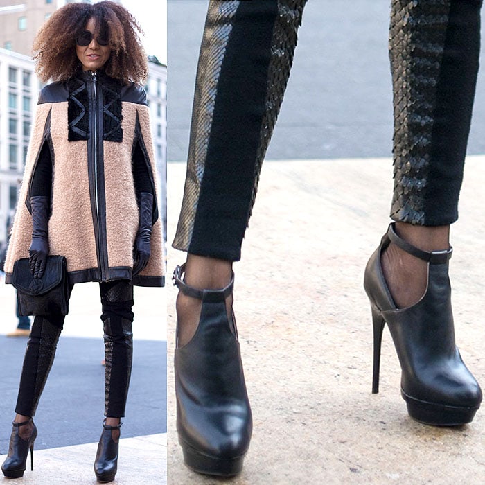 Model wears a cape coat, clutch, and snakeskin leggings