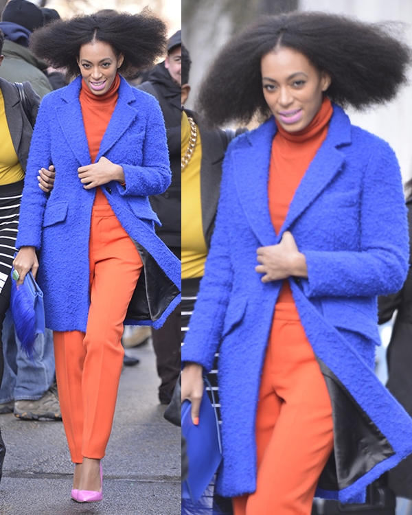 Solange Knowles wearing an orange turtleneck top with matching trousers styled with an electric blue Milly coat and a matching faux fur clutch