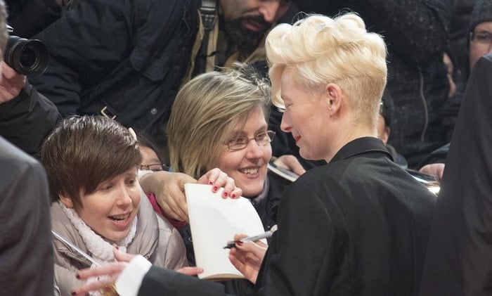 Tilda Swinton signs autographs for fans at the premiere of "The Grand Budapest Hotel"