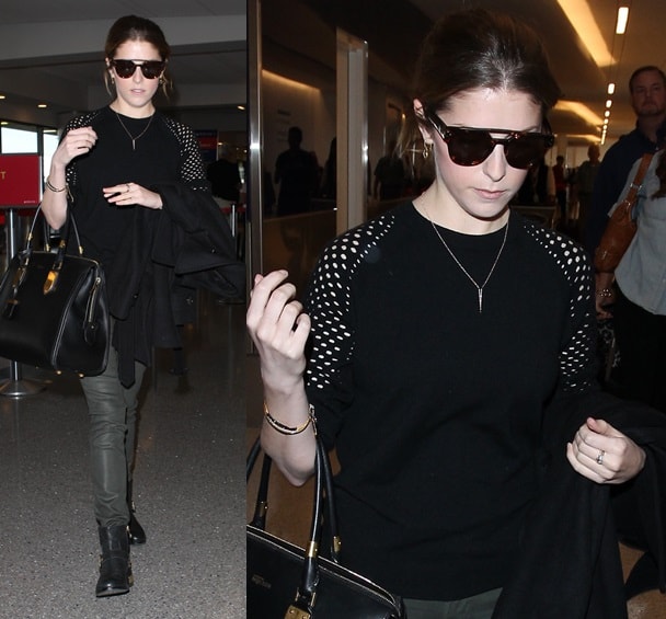 Anna Kendrick in a mesh-sleeved sweater and gold-heeled boots