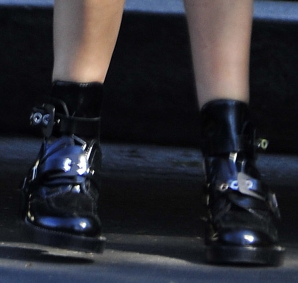 Ashley Tisdale wearing cutout buckled boots from Balenciaga