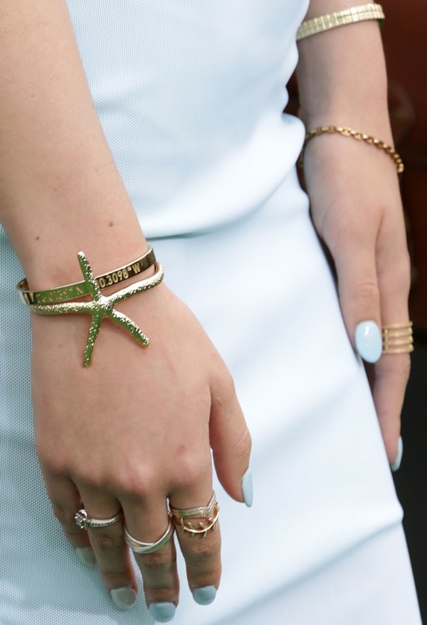 Bella Thorne showing off a starfish cuff bracelet from Pamela V and several rings from Shay Accessories
