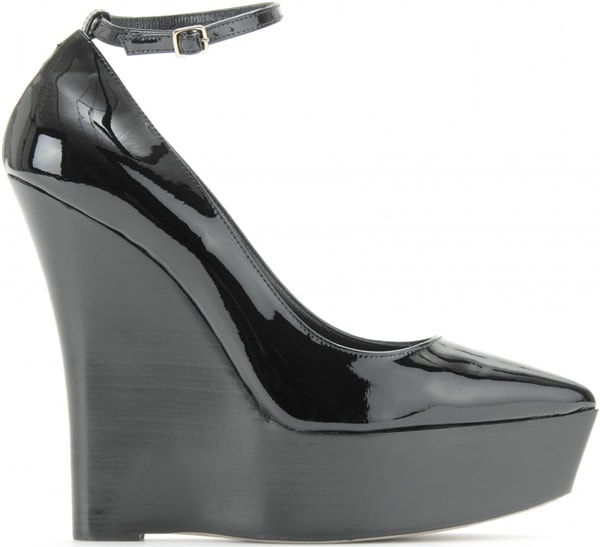 Burberry Prorsum’s “Chatsworth” platform wedges feature glossy black patent leather, sharply pointed toes, slim ankle straps, and sculptural curved platforms that create a dramatic, elongated silhouette
