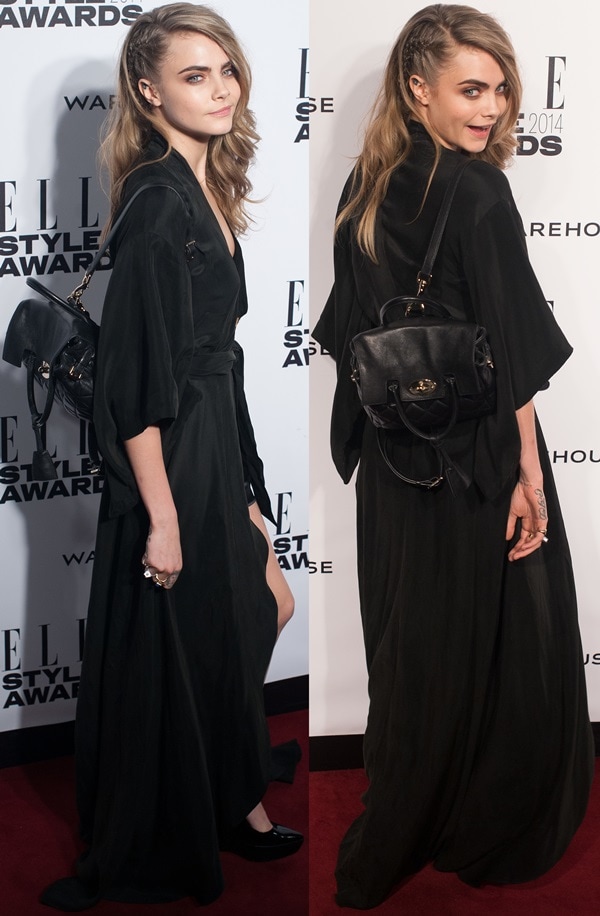 Cara Delevingne proudly displaying one of her bag designs for Mulberry at the 2014 Elle Style Awards held at One Embankment in London, England, on February 18, 2014