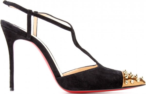 Christian Louboutin “Geotistrap” slingback pumps in black suede, designed with twisted t-straps, pointed toes, studded metallic caps, and the house’s signature red lacquered soles