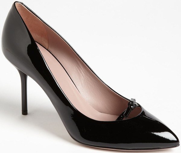 Black patent leather Gucci “Beverly” pumps featuring sleek pointed toes, slim stiletto heels, and a refined high-gloss finish that underscores their timeless, minimalist appeal