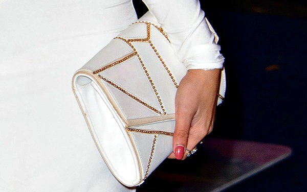 Jasmin Walia totes a white clutch