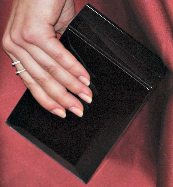 Sarah Hyland showcasing her sleek black Rauwolf clutch