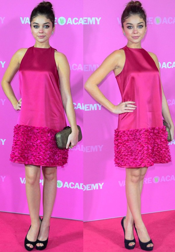 Sarah Hyland’s satin magenta shift dress with a textured hemline is grounded by classic black peep-toe pumps for a clean, modern finish