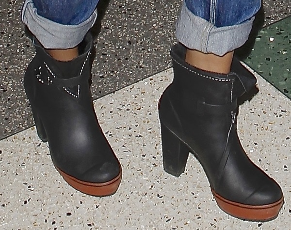 Selena Gomez's chic Sorel rain ankle boots, perfect for stylish and comfortable travel