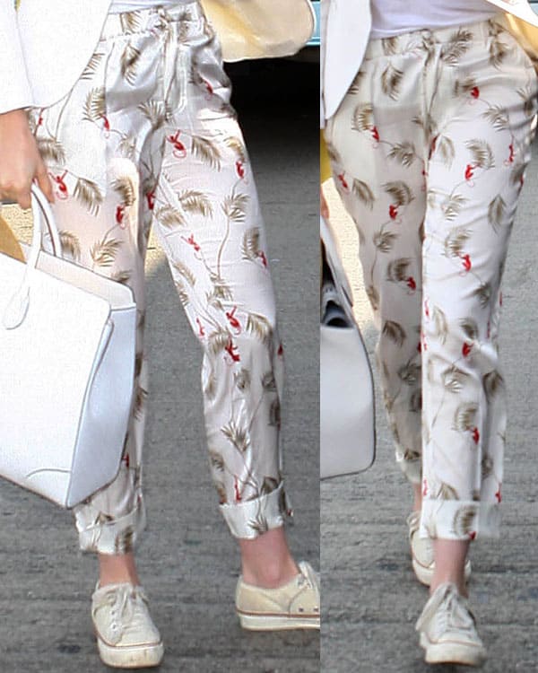 Anne Hathaway wearing quirky Piamita "Alexa" trousers with monkeys and palm tree prints