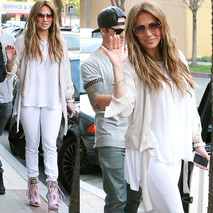 The neutral layers and all-white separates keep the focus firmly on Lopez's embellished Giuseppe Zanotti booties, proving how a bold pair of shoes can anchor an otherwise understated outfit