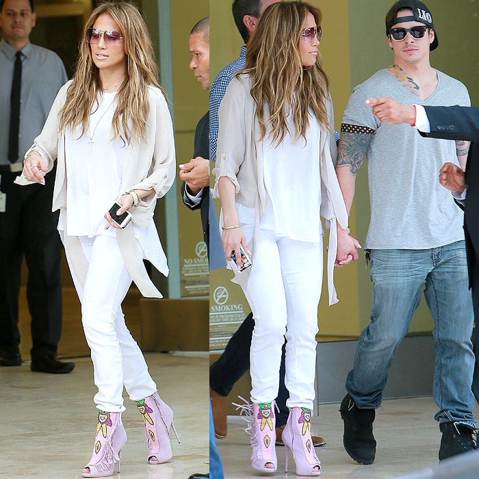 Jennifer Lopez pairing a pale chiffon jacket and white skinny jeans with eye-catching pink Giuseppe Zanotti booties and coordinating oversized sunglasses