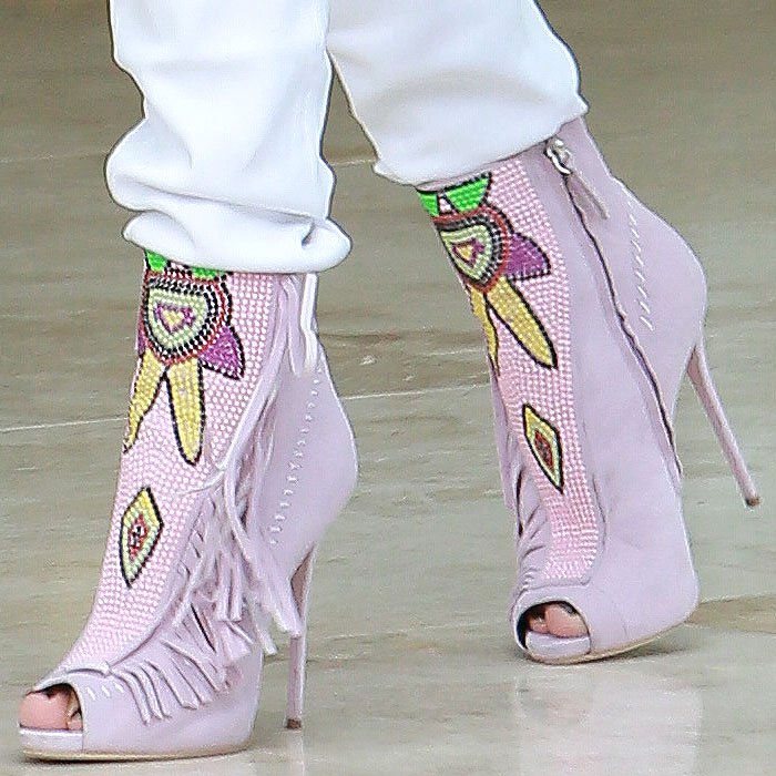 Seen from the side, the towering stiletto heel, sculpted platform, and cascading suede fringe showcase the dramatic craftsmanship behind Giuseppe Zanotti's Spring 2014 design