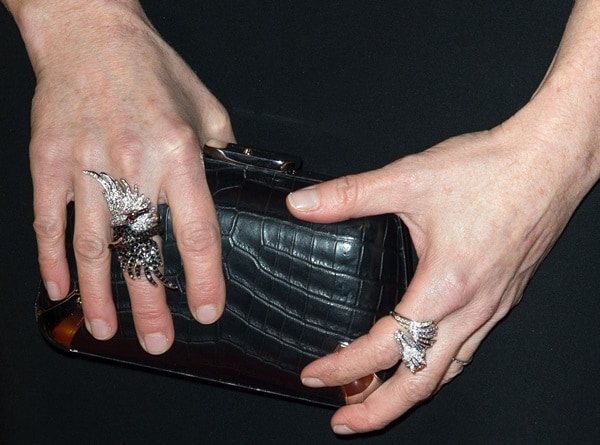 Julianne Moore showcases statement diamond rings while clutching a black crocodile-embossed Balenciaga minaudière — a sleek, sculptural accessory that adds texture and edge to her red-carpet look