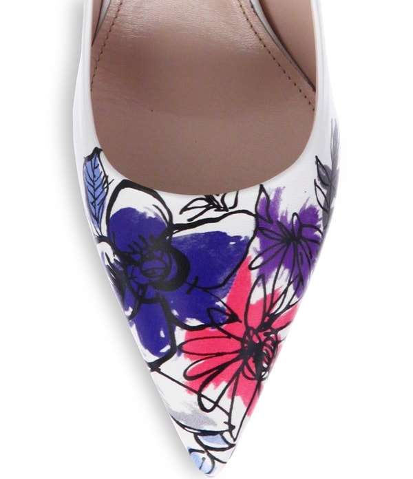 A close-up of Miu Miu’s painted flower-toe leather pumps, featuring hand-drawn floral motifs that add a playful, artistic twist to the pointed silhouette