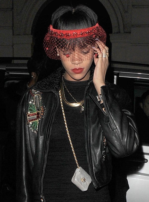 Rihanna accessorized with a Chanel silver lambskin mini crossbody necklace bag and a striking Silver Spoon Attire crystal headband with a mesh veil
