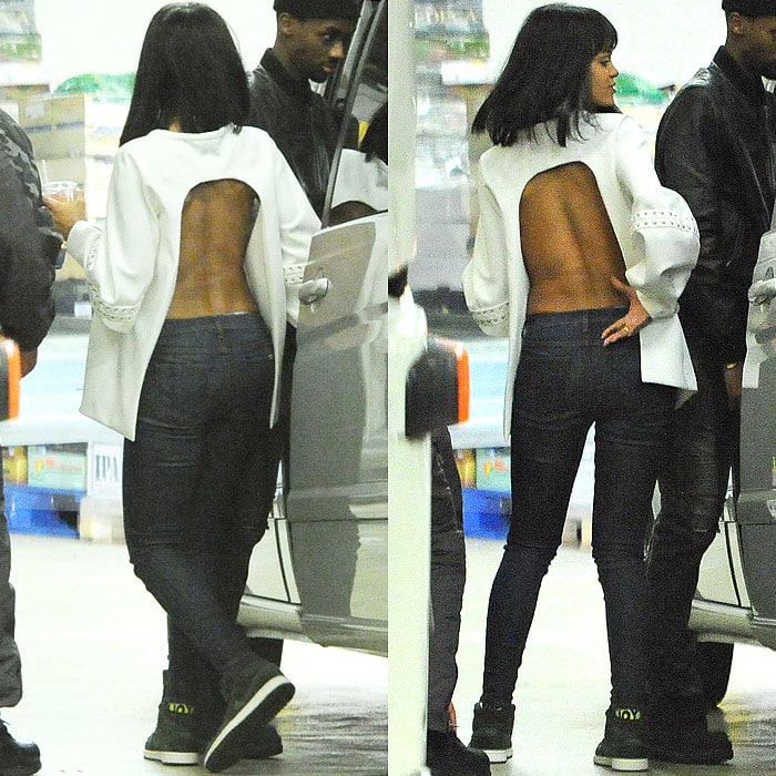 Rihanna turned heads in a bold backless top paired with sleek skinny jeans and statement sneakers as she made her way into the Cirque le Soir club