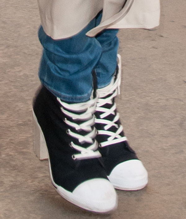 A close-up of Rita Ora's bold footwear choice—DKNY for Opening Ceremony high-heel sneakers—blending sporty high-tops with a chic block heel for an edgy streetwear twist