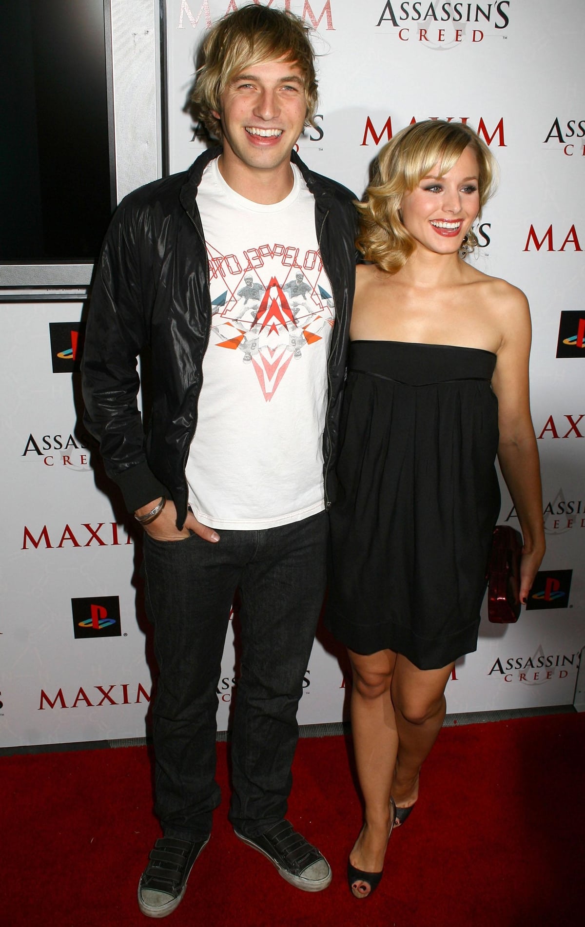 Kristen Bell keeps it chic in a strapless black mini dress and peep-toe heels while posing with Ryan Hansen at the Maxim and Ubisoft Assassin’s Creed launch party