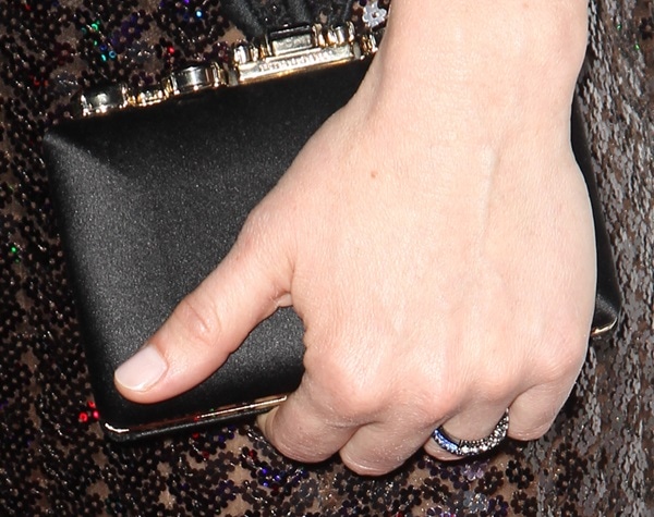 Sarah Paulson pairs her sequined Marc Jacobs dress with a sleek black satin clutch featuring a metallic frame, adding a refined finish to her 2014 Producers Guild of America Awards look