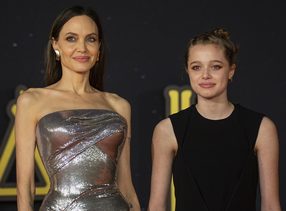 Angelina Jolie and her daughter Shiloh Jolie-Pitt share a striking mother-daughter moment at the Eternals Rome Film Fest premiere, contrasting Jolie’s gleaming metallic Versace gown with Shiloh’s youthful black mini dress and braided updo