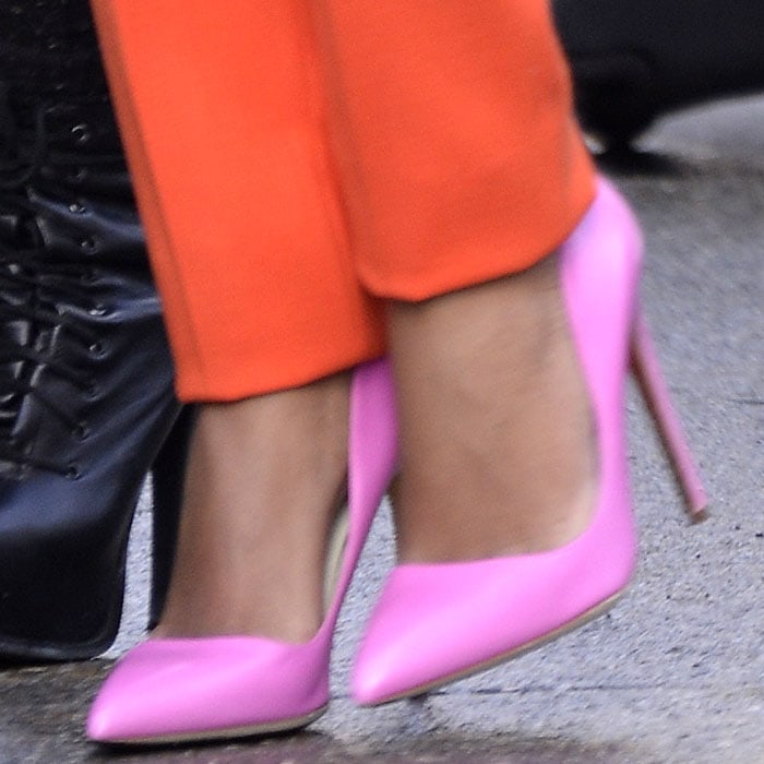Solange Knowles’ bubblegum-pink Rupert Sanderson pumps deliver a sharp, polished finish, their pointed toes and slim heels popping vividly against her cropped orange trousers