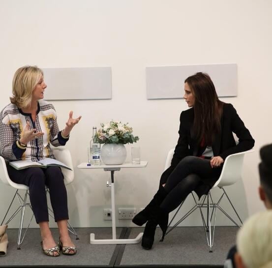 Susie Forbes and Victoria Beckham conversing during a QA classroom discussion at the Condé Nast College of Fashion Design in London, England, on March 12, 2014