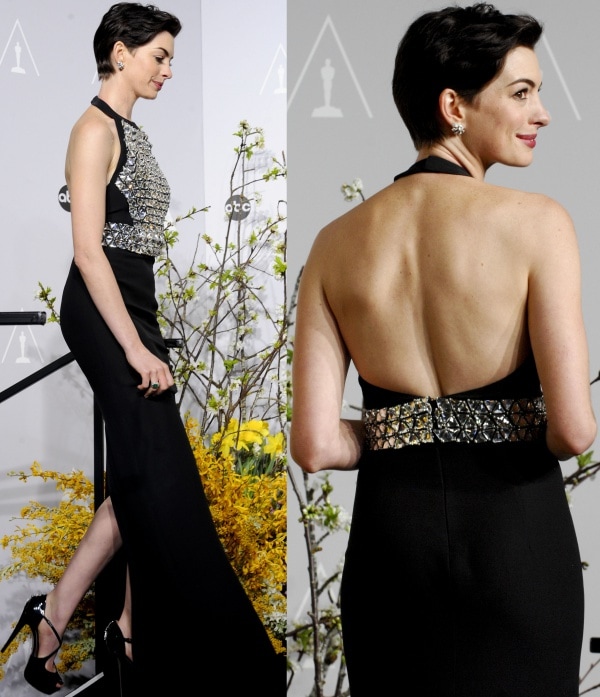 Anne Hathaway stuns in a sleek black Gucci gown featuring a crystal-embroidered bodice and an open-back design at the 86th Academy Awards