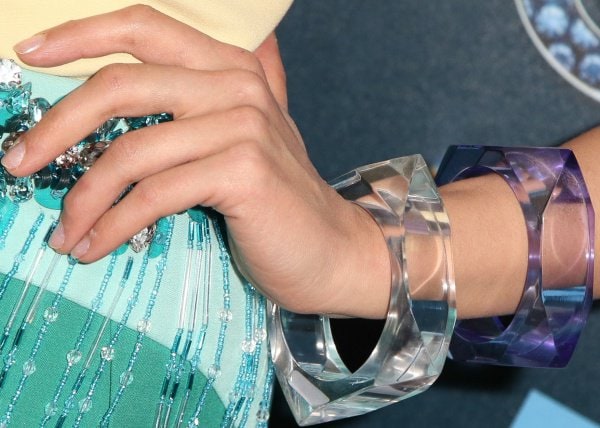 Dianna Agron adds a modern, sculptural edge with oversized translucent cuffs, their faceted acrylic design contrasting beautifully against her embellished, jewel-toned ensemble