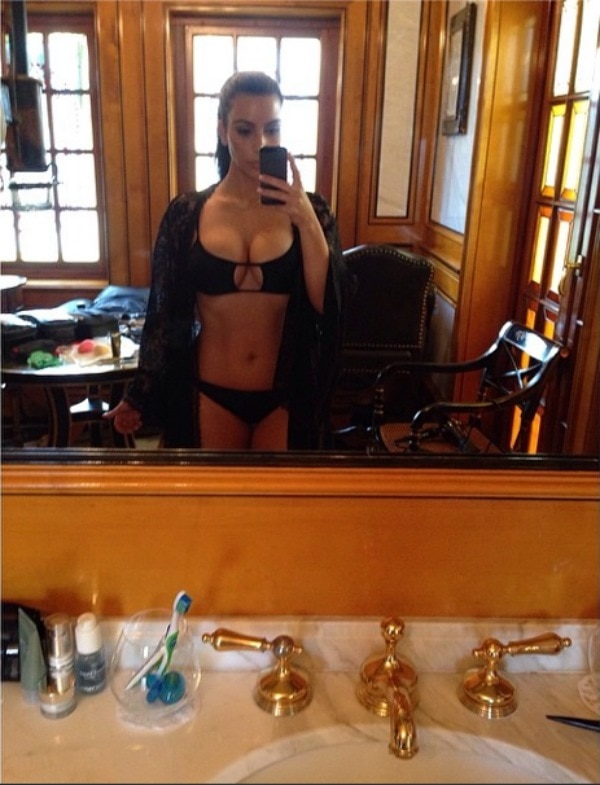 Kim Kardashian’s Instagram photo captioned “Quick swim before the Dash party!”—posted on March 13, 2014—shows her flaunting a sleek black bikini with a cutout top and lace cover-up, highlighting her signature glam-before-a-party style