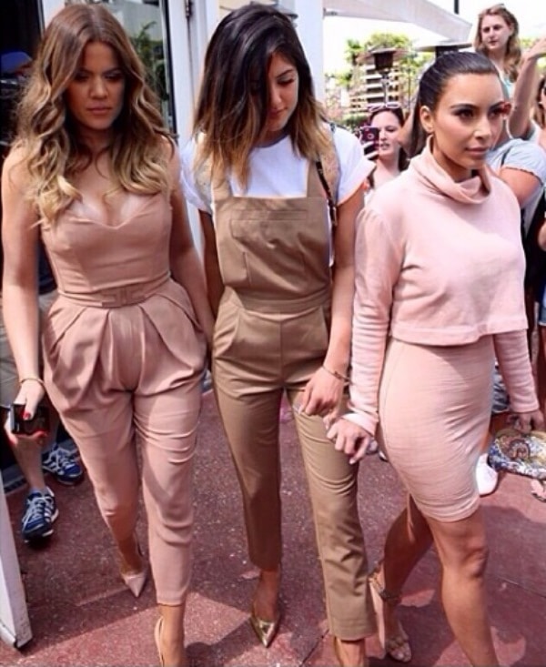 Kylie Jenner’s Instagram photo captioned ‘Always by my side,’ posted on March 13, 2014, showing her walking with Khloé and Kim Kardashian in coordinated neutral-toned outfits.