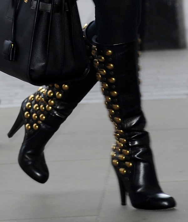 Kylie Minogue completes her gold-on-black look with stunning knee-high boots