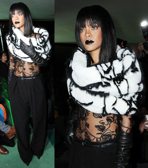 Rihanna stunning in a sheer lace top, black pants, and a striking fur stole at the Jean-Paul Gaultier show