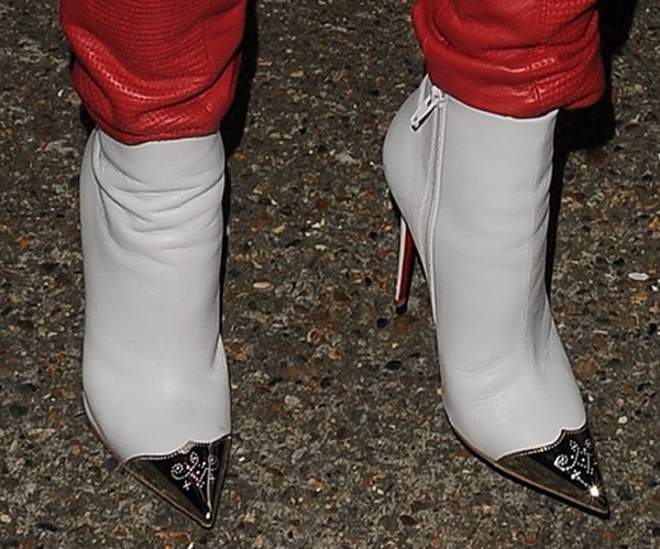 Rita Ora steps out in stunning white Christian Louboutin ankle boots featuring sleek metallic toe caps and the brand's signature red soles