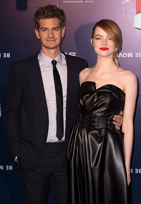 Andrew Garfield and Emma Stone arrive at the Paris premiere of The Amazing Spider-Man 2, with Stone embracing a sculptural, strapless black look that sharpens the evening’s all-black mood
